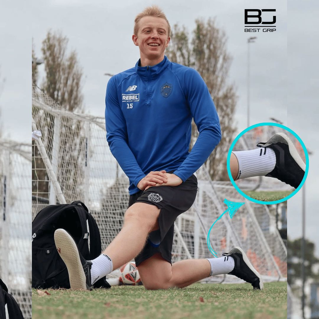 Person in sports attire on a soccer field wearing best grip socks nz