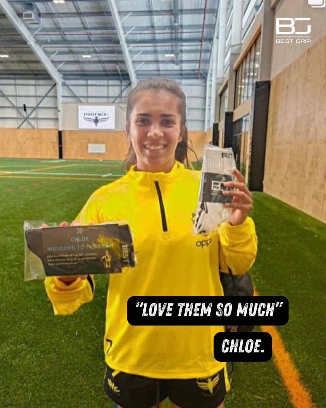 Person in yellow jacket holding sports equipment in an indoor sports facility