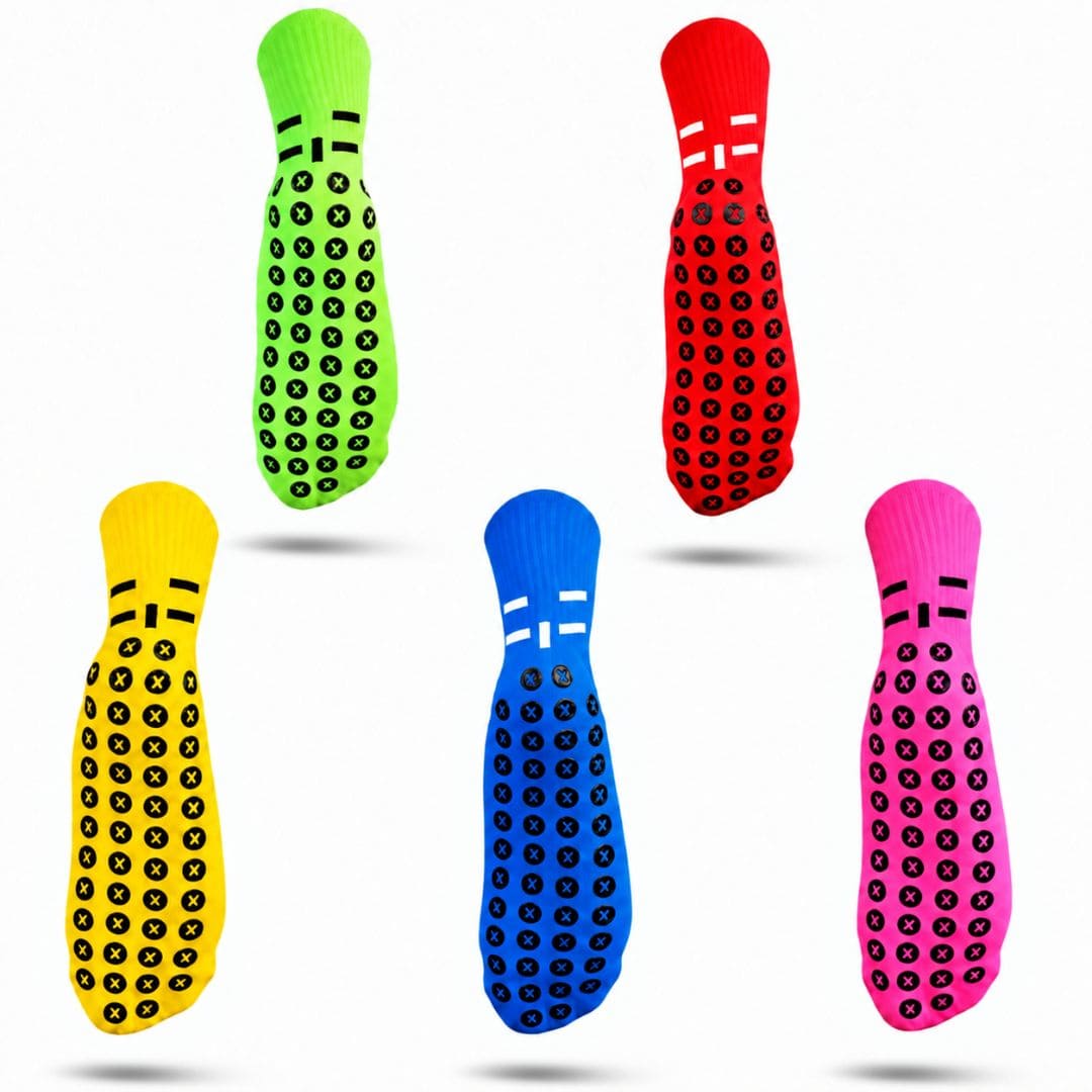 Five colorful grip socks arranged on a plain white background, each with a different bright base color (green, red, yellow, blue, pink) covered in black circular grip dots.