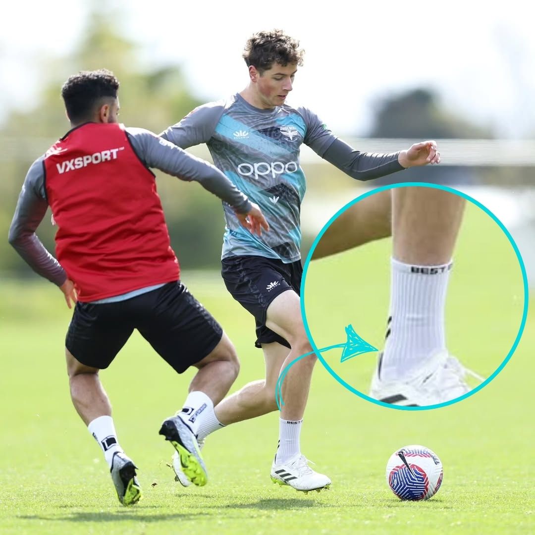 Wellington Phoenix player wearing white Pro Best Grip Socks during football training, with a close-up highlighting the Best Grip branding. These performance grip socks feature XCORE Grip™ pads for traction inside football boots and sweat-wicking, quick-drying TactiWeave™ fabric for comfort.