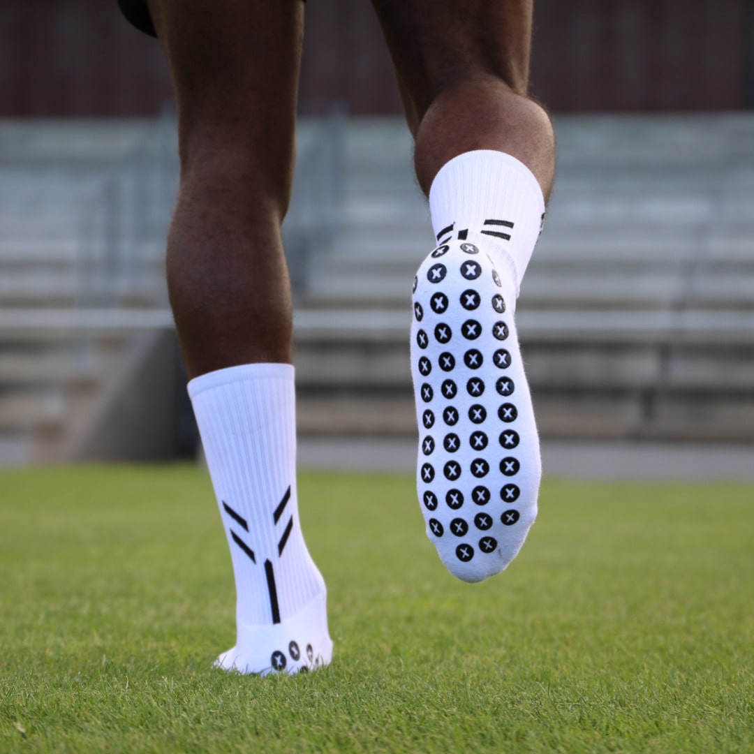 Close-up of Best Grip white crew grip socks featuring XCORE Grip™ technology with 48 premium anti-slip silicone grip pads designed to reduce foot movement inside boots, improve traction, stability and control, and deliver a secure locked-in fit for football, rugby and other sports.